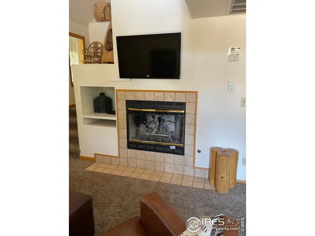 a living room with furniture and a lamp