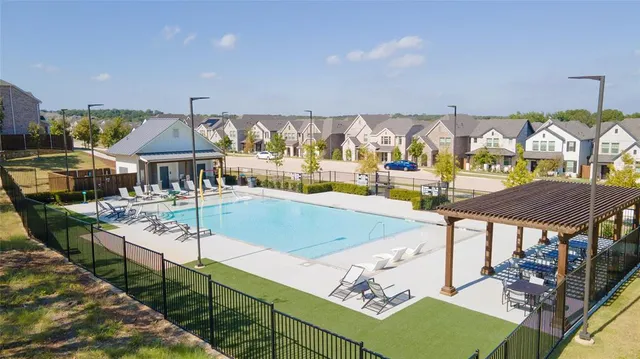 a view of a patio with chairs and umbrellas