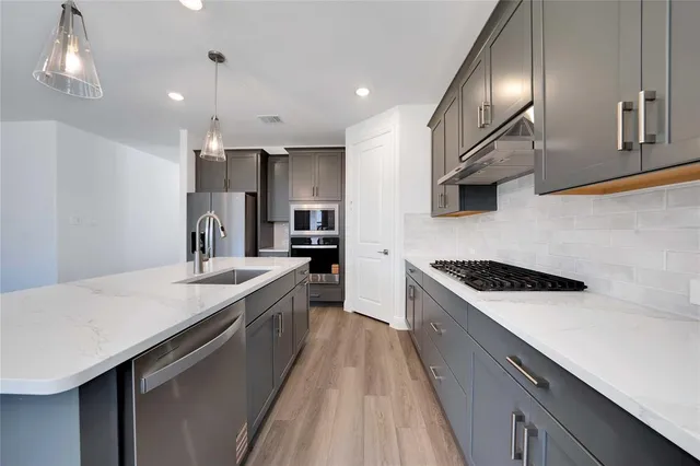 a kitchen with a sink stove and refrigerator