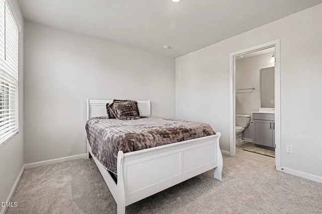 a bedroom with a bed and a night stand