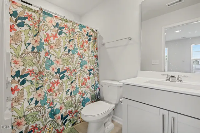 a en suite bathroom with a sink a large mirror and shower