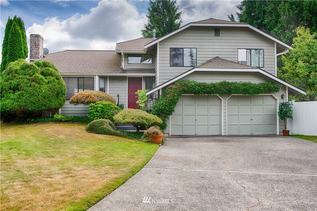 7902 211th Place Southwest Edmonds, WA 98026 - Photo 2 of 33 a front view of a house with a yard and garage