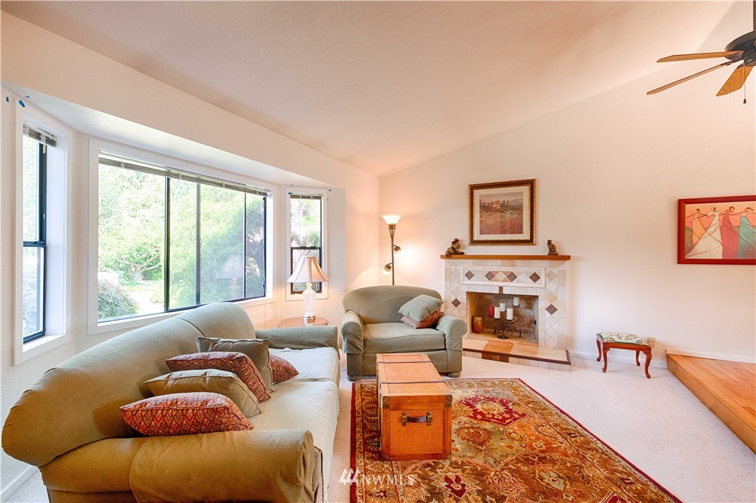 7902 211th Place Southwest Edmonds, WA 98026 - Photo 11 of 33 a living room with furniture fireplace and a large window