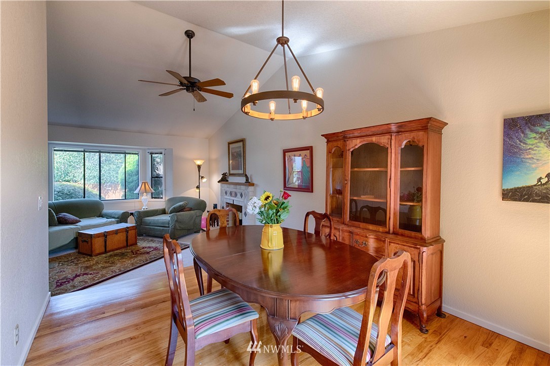 7902 211th Place Southwest Edmonds, WA 98026 - Photo 14 of 33 a view of a dining room with furniture window and wooden floor
