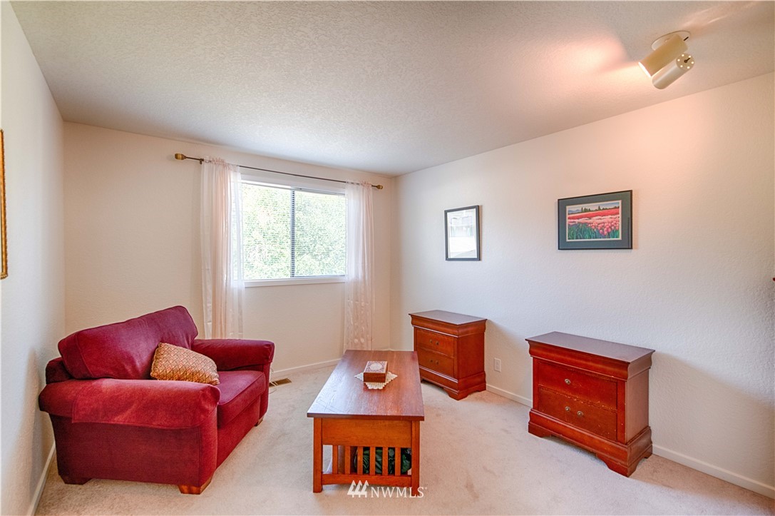 7902 211th Place Southwest Edmonds, WA 98026 - Photo 18 of 33 a living room with furniture a lamp and a window
