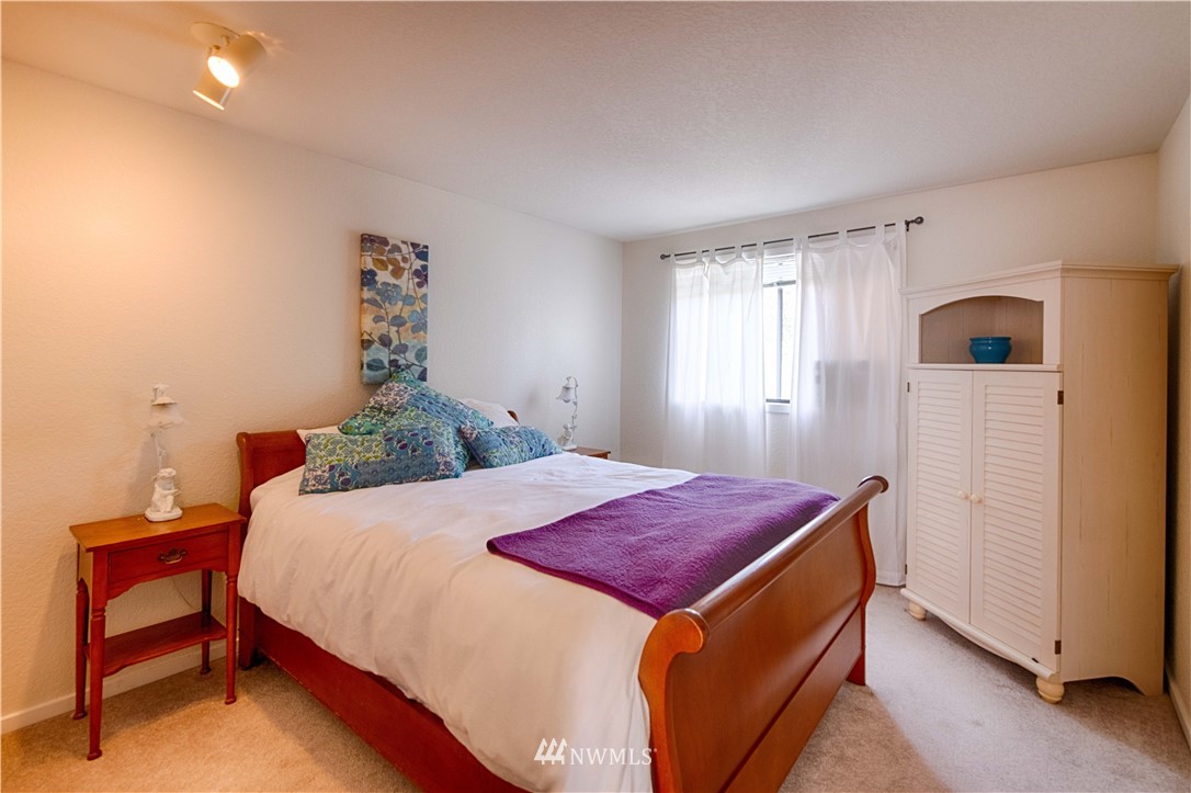 7902 211th Place Southwest Edmonds, WA 98026 - Photo 19 of 33 a bedroom with a bed and a dresser in it