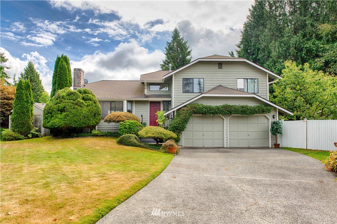 7902 211th Place Southwest Edmonds, WA 98026 - Photo 3 of 33 a front view of a house with a yard and garage
