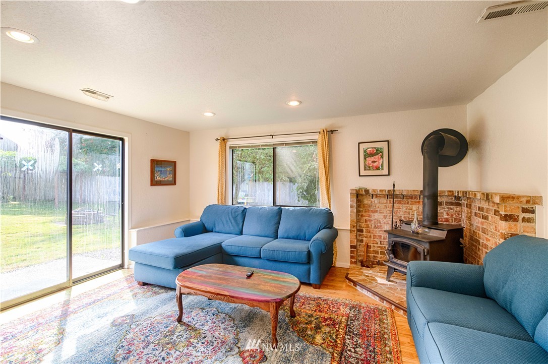 7902 211th Place Southwest Edmonds, WA 98026 - Photo 23 of 33 a living room with furniture and a floor to ceiling window