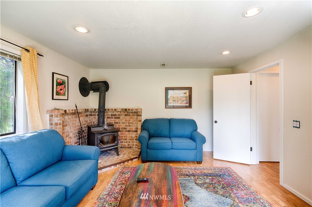 7902 211th Place Southwest Edmonds, WA 98026 - Photo 24 of 33 a living room with furniture ceiling fan and a wooden floor