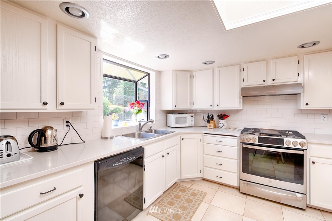 7902 211th Place Southwest Edmonds, WA 98026 - Photo 29 of 33 a kitchen with cabinets appliances a sink and a window