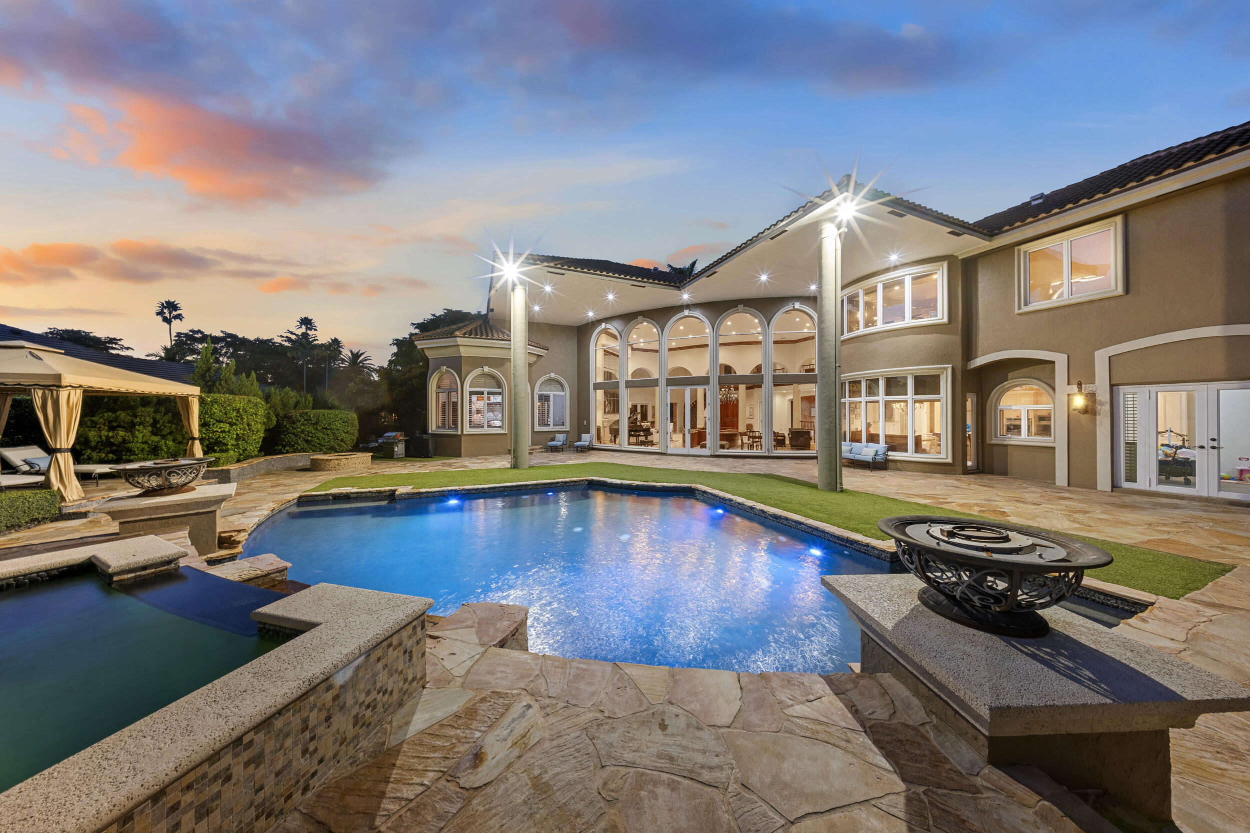 a view of a house with swimming pool and sitting area