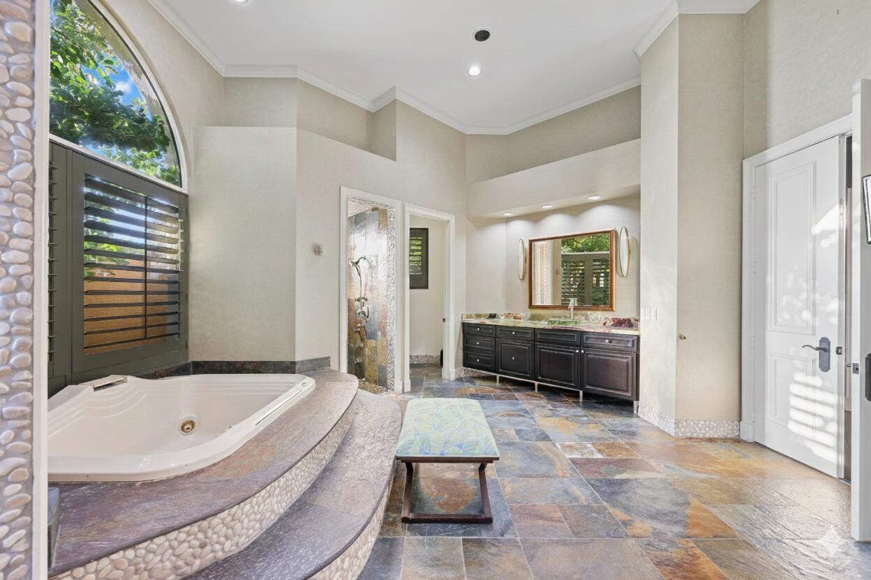 21169 Oakley Court Boca Raton, FL 33433 - Photo 22 of 60 a bathroom with a tub a mirror and a shower