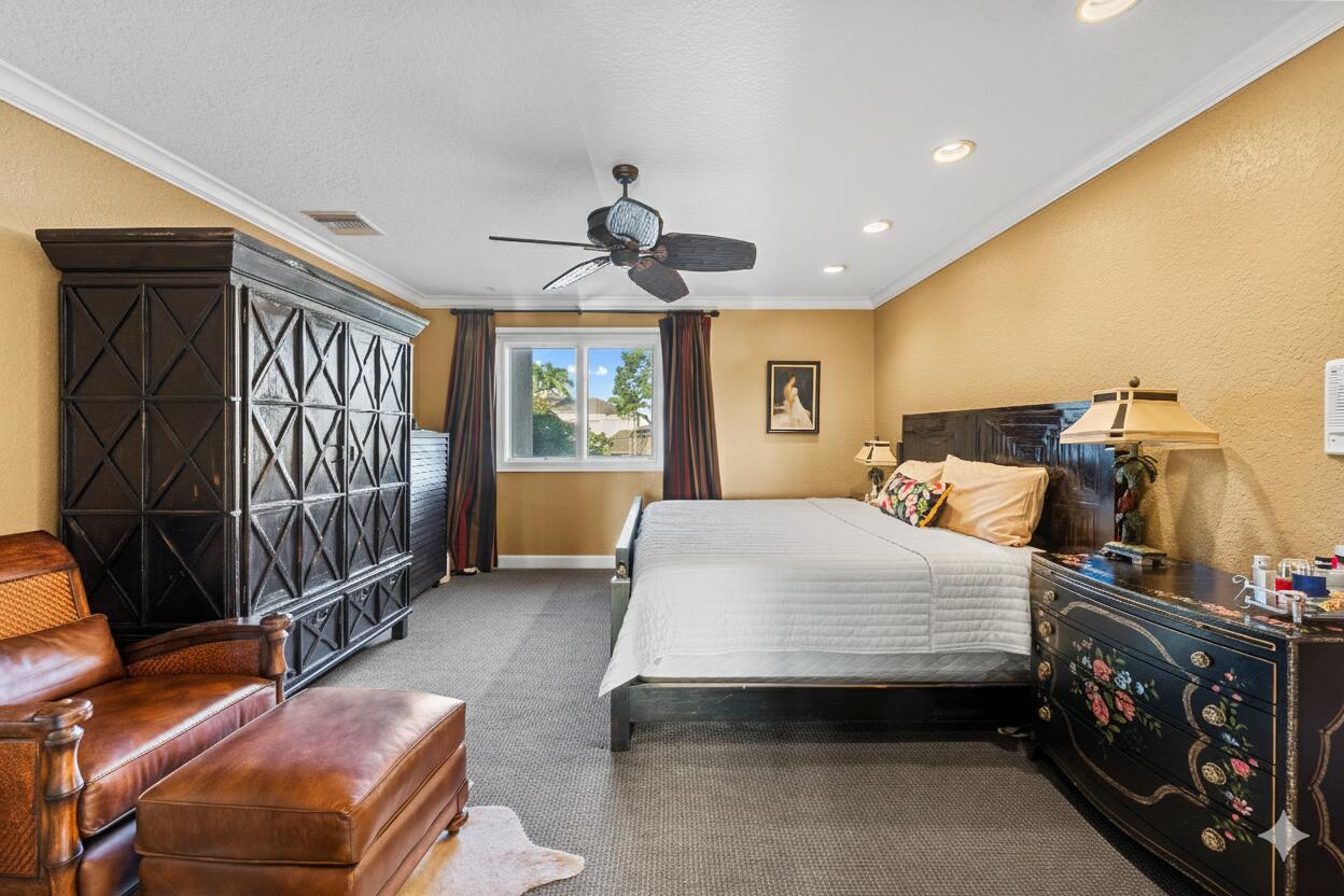 21169 Oakley Court Boca Raton, FL 33433 - Photo 33 of 60 a bedroom with a bed and a chandelier