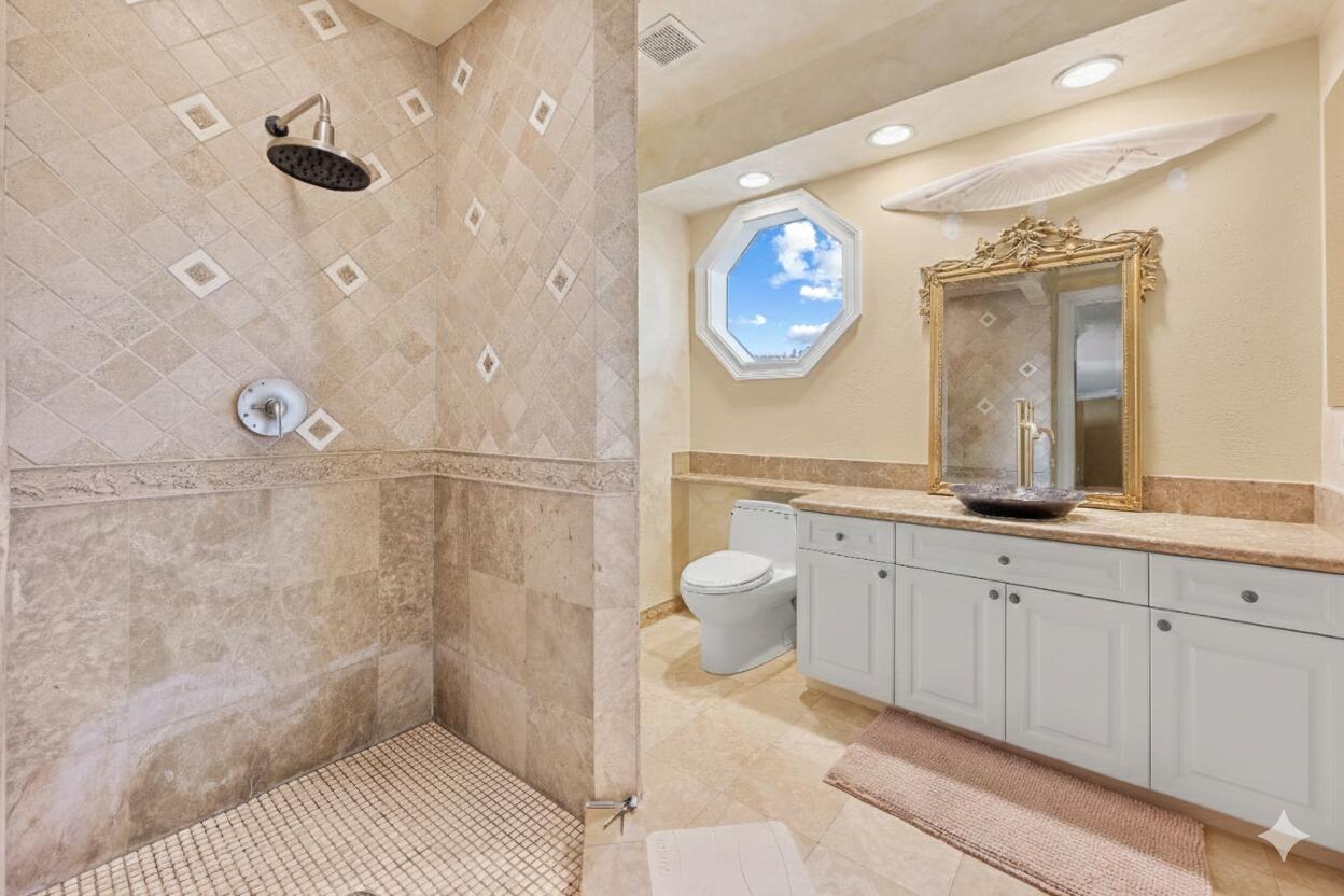 21169 Oakley Court Boca Raton, FL 33433 - Photo 34 of 60 a spacious bathroom with a sink a mirror and a shower