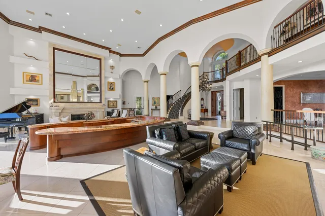 a living room with furniture a fireplace and a large window