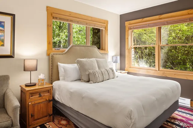 a bedroom with a bed and large window