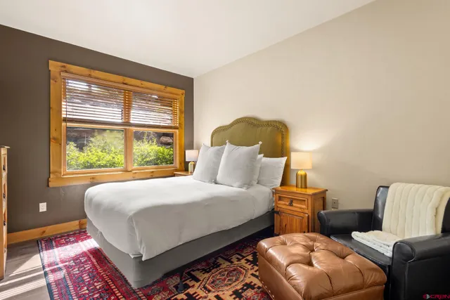 a bedroom with a bed and window