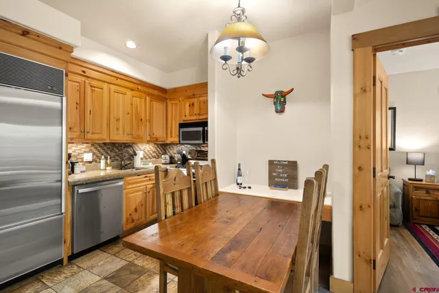 a kitchen with stainless steel appliances granite countertop a sink refrigerator stove and microwave