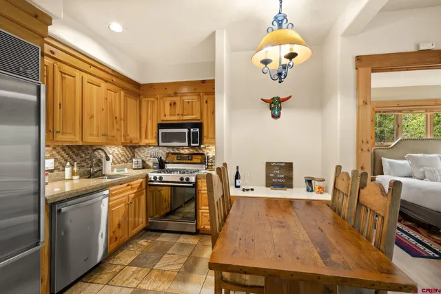 a kitchen with a sink appliances and cabinets