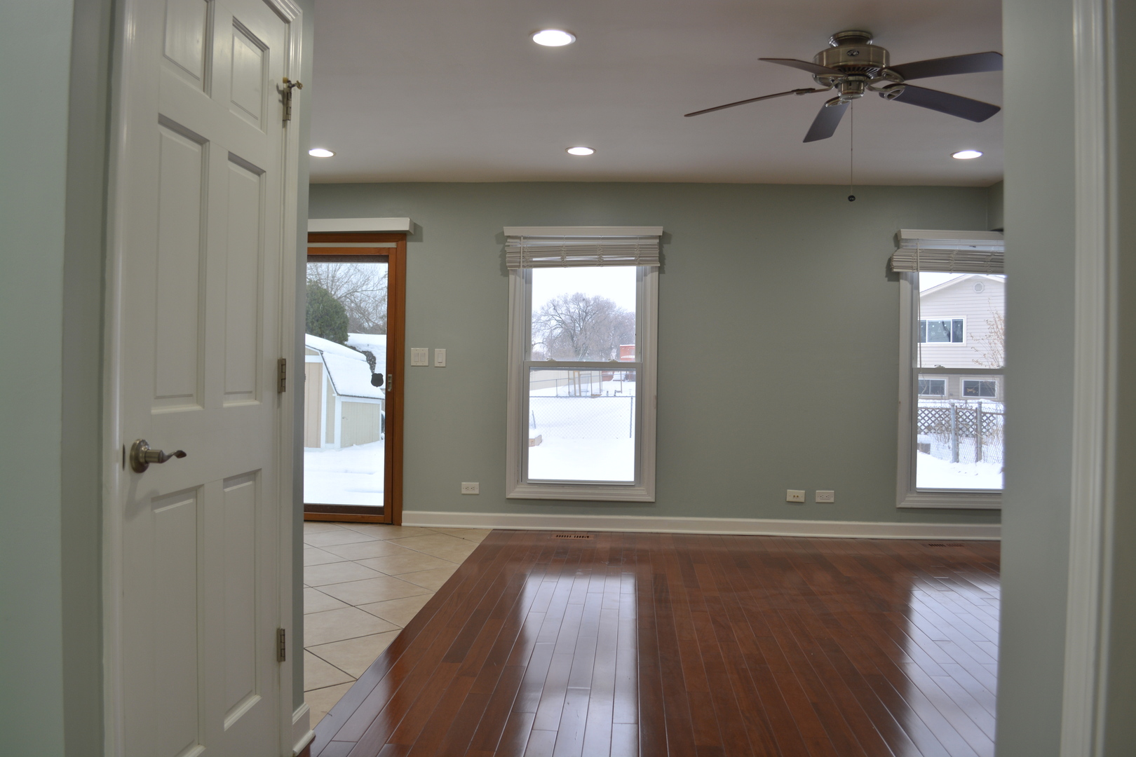 1203 Timber Drive Elk Grove Village, IL 60007 - Photo 12 of 32 a view of an empty room with a window and wooden floor