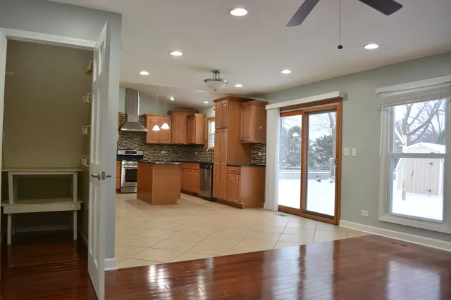 a view of kitchen with refrigerator and microwave