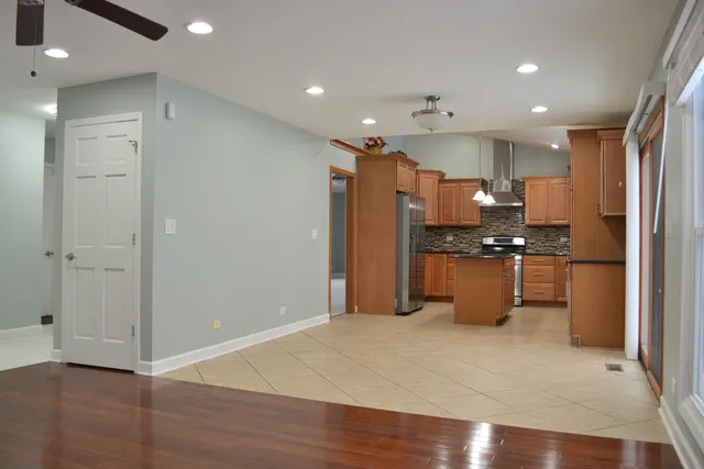 a kitchen with stainless steel appliances granite countertop a sink a stove and a refrigerator