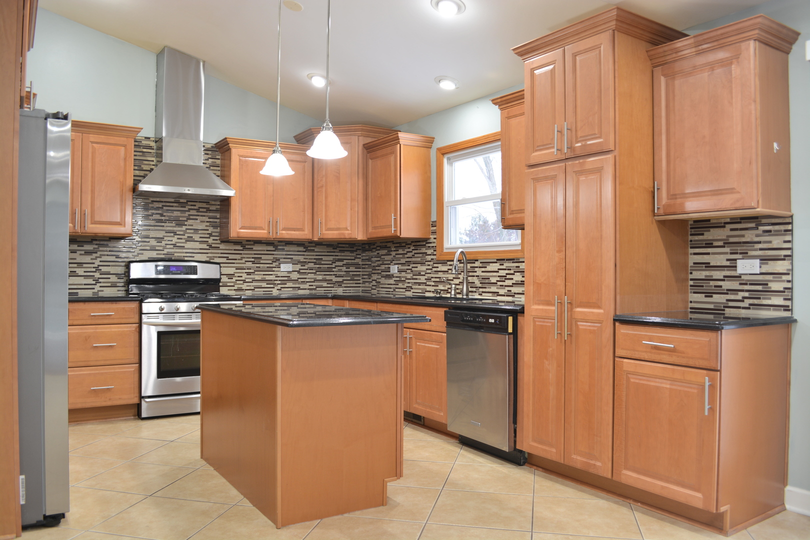 1203 Timber Drive Elk Grove Village, IL 60007 - Photo 18 of 32 a kitchen with stainless steel appliances granite countertop a sink a stove and a refrigerator