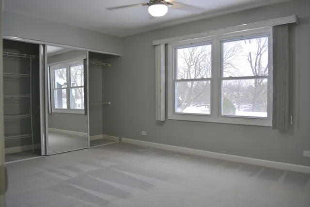 a bathroom with a toilet sink vanity and mirror