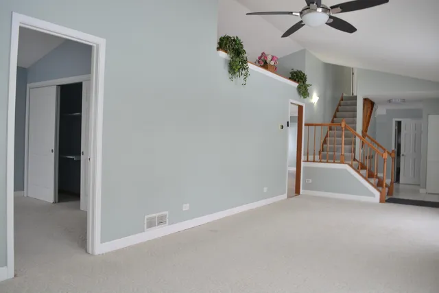 a view of a hallway with entryway and chandelier