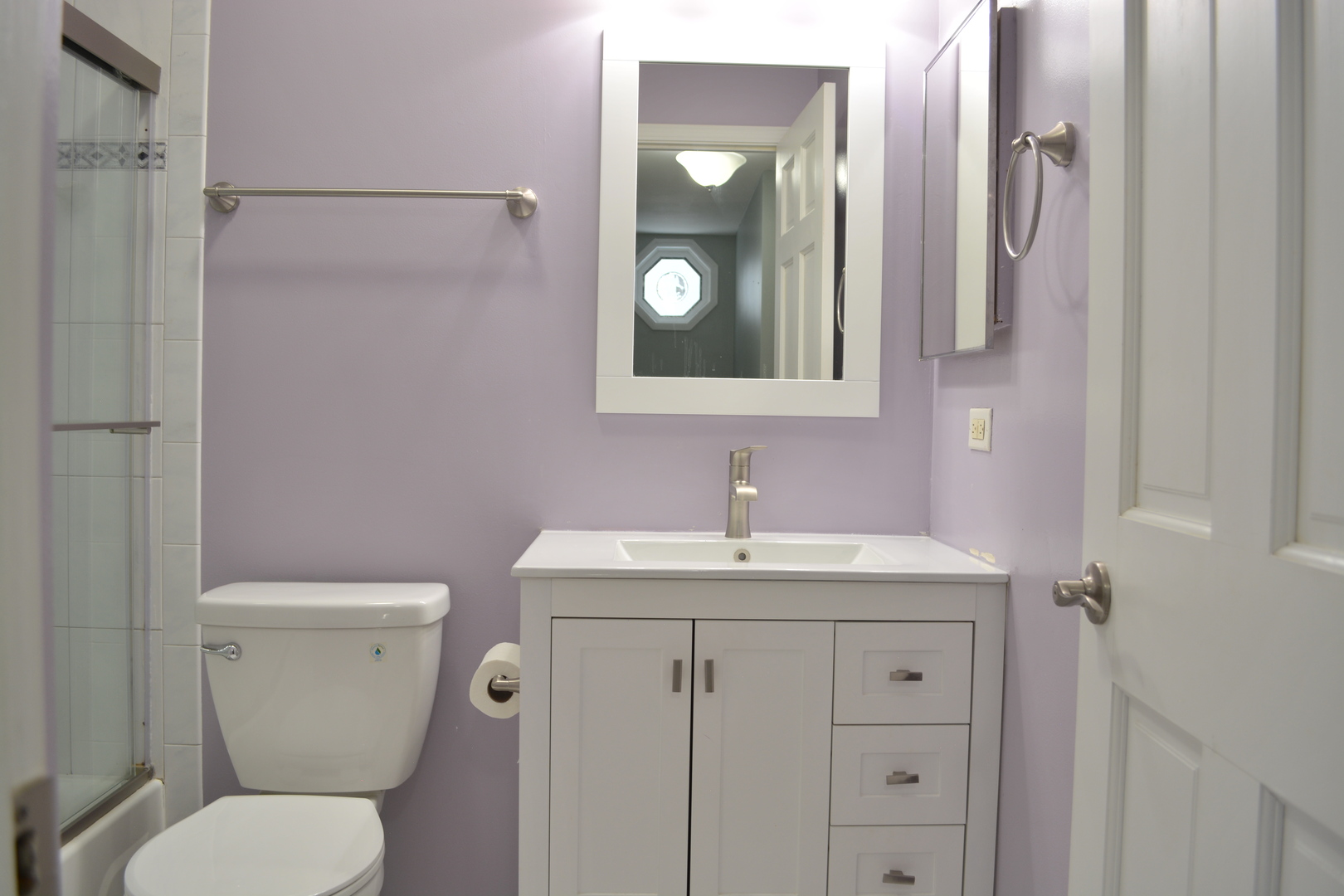 1203 Timber Drive Elk Grove Village, IL 60007 - Photo 31 of 32 a bathroom with a toilet sink vanity and mirror