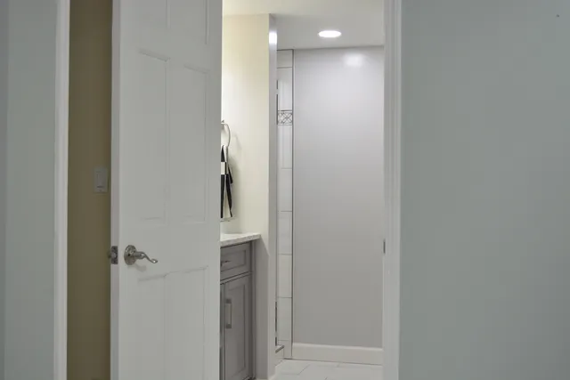 a bathroom with a granite countertop sink vanity and a mirror