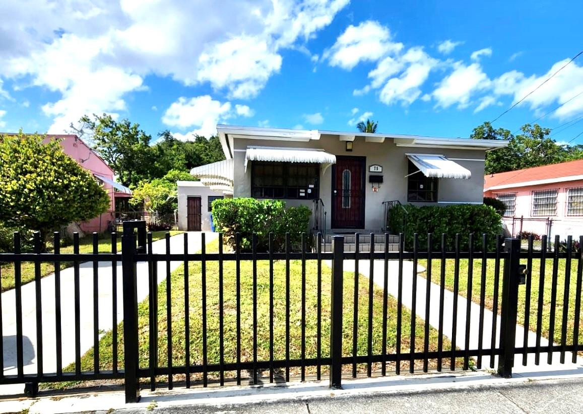 75 Northwest 52nd Street Miami, FL 33127 - Photo 2 of 12 a front view of a house with a garden