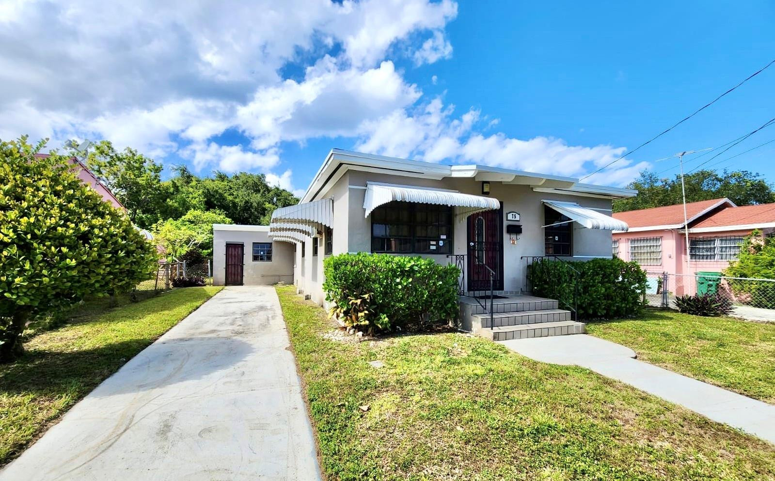 75 Northwest 52nd Street Miami, FL 33127 - Photo 3 of 12 front view of a house with a yard
