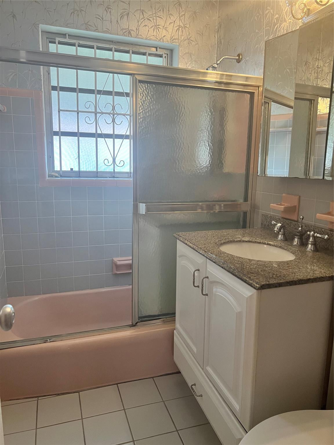 75 Northwest 52nd Street Miami, FL 33127 - Photo 8 of 12 a bathroom with a granite countertop sink a mirror and a bathtub