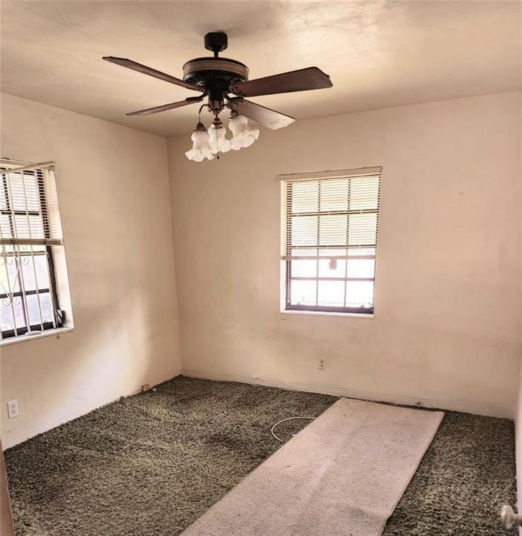 75 Northwest 52nd Street Miami, FL 33127 - Photo 9 of 12 a view of a livingroom with a ceiling fan and window