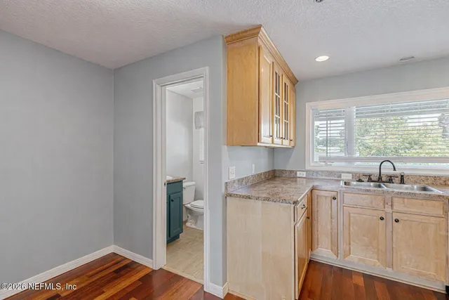 a kitchen with a sink stove and cabinets