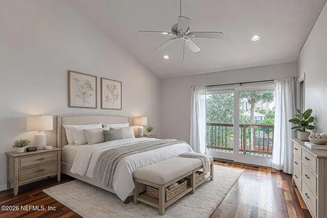 a spacious bedroom with a bed and a large window