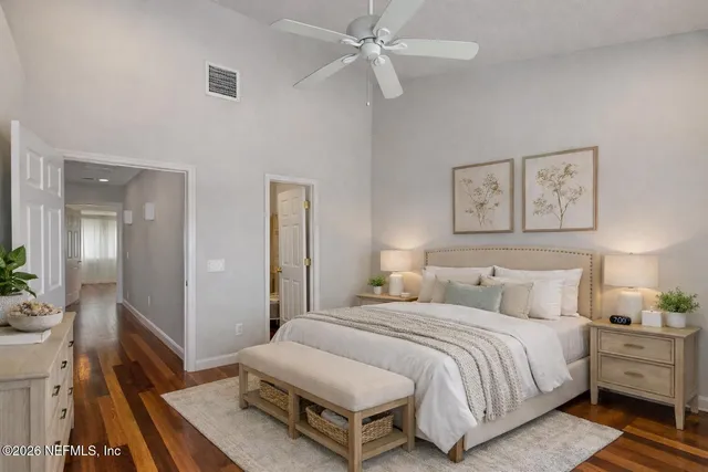 a spacious bedroom with a bed and a dresser