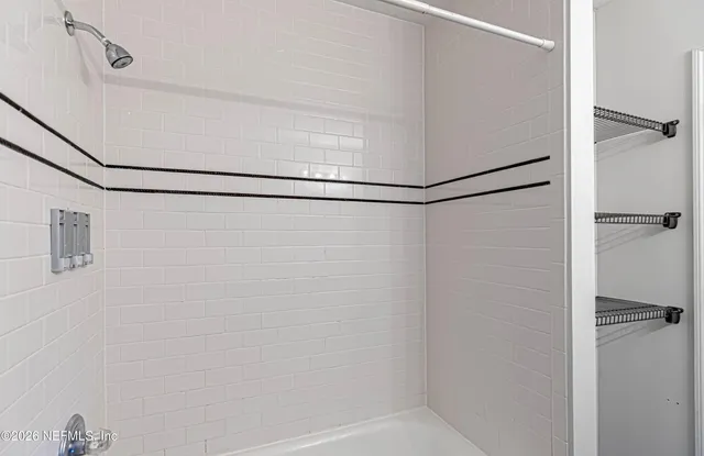 a bathroom with a glass shower door