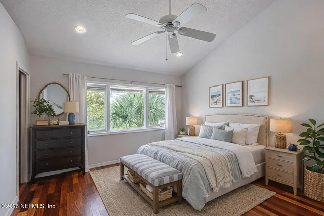 a spacious bedroom with a bed and a dresser