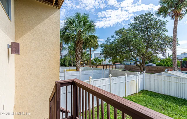 a view of a balcony with trees
