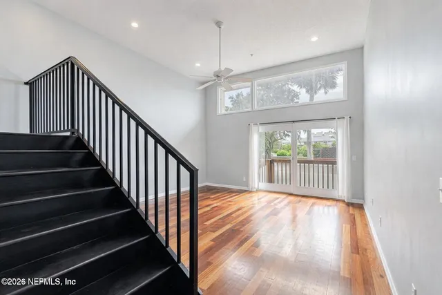 a view of entryway and hall with wooden floor