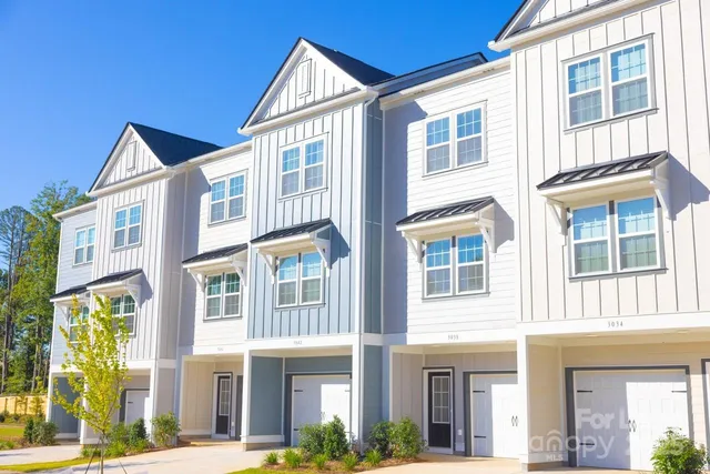 a view of a brick building next to a yard