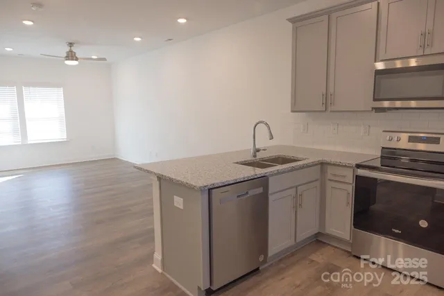 a kitchen with a sink cabinets and stainless steel appliances