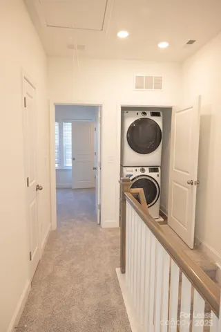 a view of a kitchen with a washer and dryer
