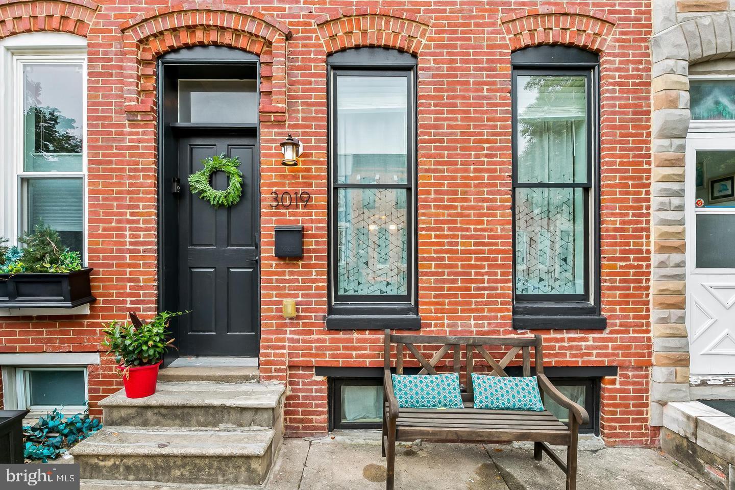 3019 Keswick Road Baltimore, MD 21211 - Photo 1 of 29 a front view of a house with a garden and sitting area