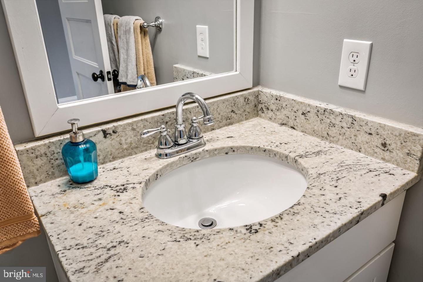 3019 Keswick Road Baltimore, MD 21211 - Photo 19 of 29 a bathroom with a granite countertop sink and a mirror