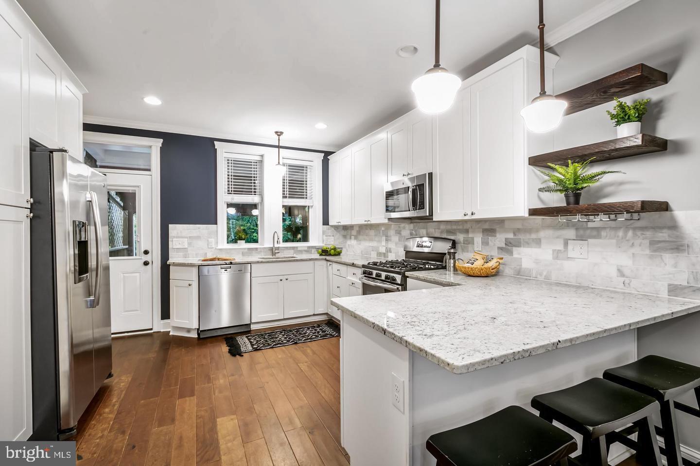 3019 Keswick Road Baltimore, MD 21211 - Photo 3 of 29 a kitchen with white cabinets and stainless steel appliances