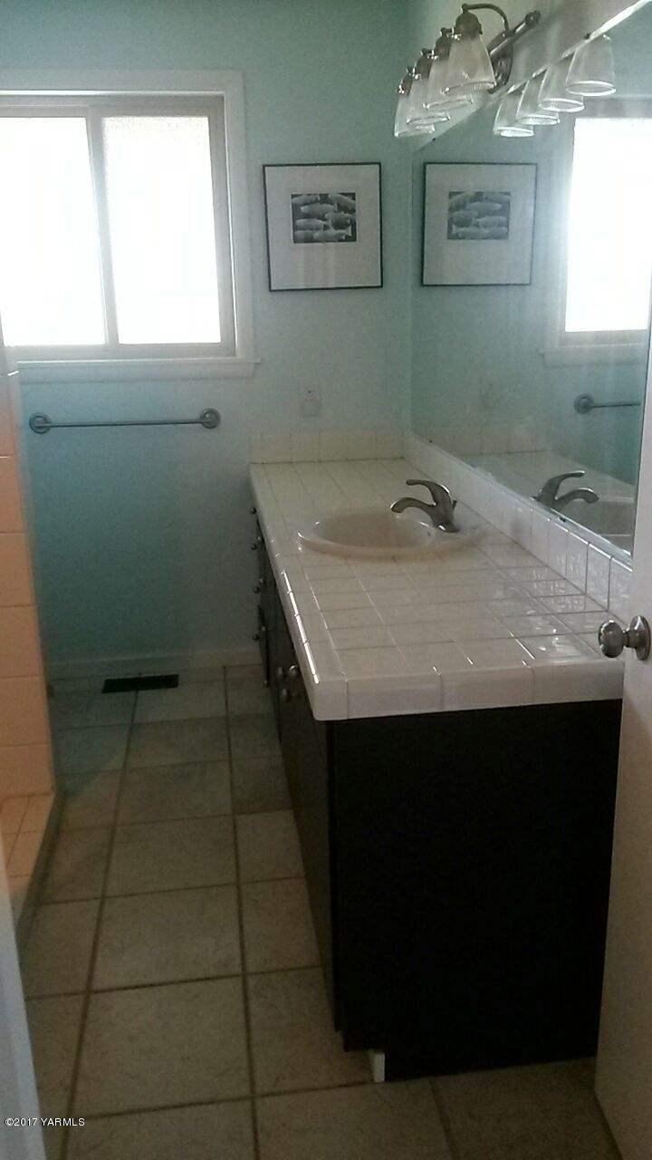 11604 Summitview Ext Road Yakima, WA 98908 - Photo 11 of 41 a room with a sink a toilet and window