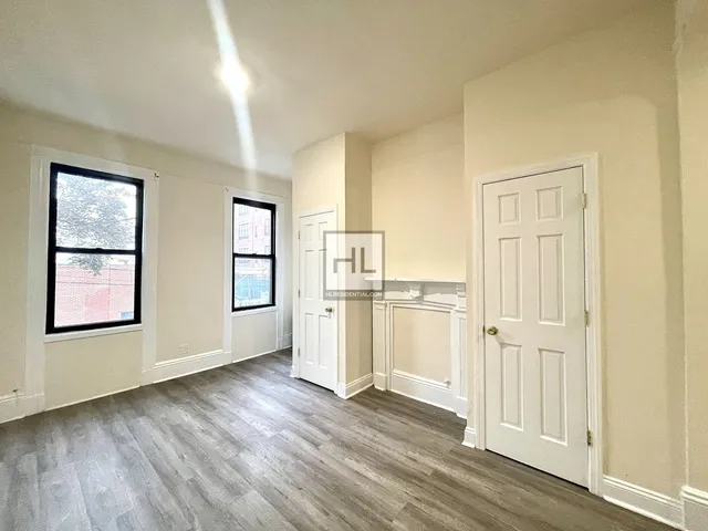 a view of a kitchen with wooden floor and windows